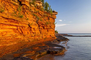 Images Dated 18th September 2010: Layered sandstone cliffs and sea caves at sunrise on Devils Island in the Apostle