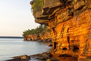 Images Dated 18th September 2010: Layered sandstone cliffs and sea caves at sunrise on Devils Island in the Apostle