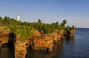 Images Dated 18th September 2010: Layered sandstone cliffs and sea caves at sunrise on Devils Island Lighthouse in