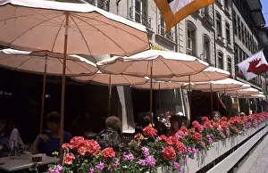 Outdoor Cafe Prints: Life in Switzerland colorful flowers and cafe in beautiful city of Bern Switzerland