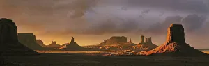 Reservation Prints: Last light bathes Monument Valley in deep oranges and lavenders on the Arizona