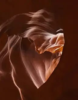 Reservation Prints: Light beams down into Upper Antelope Canyon forming a heart shape on the Navajo Reservation
