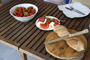 Light lunch of strawberries, tomato, cheese, and bread in Switzerland