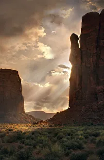 Stormy Prints: Light rays filter down into Monument Valley, on the Arizona and Utah border