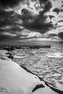 Prints of A light snowfall and contrasting darker terrain define the rugged landscape of Canyonlands National Park Images Dated 2024 November: A light snowfall and contrasting darker terrain define the rugged landscape of Canyonlands National Park