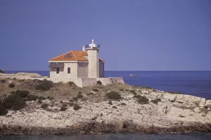 A lighthouse anchors the south east tip of the island of Solta. Adriatic Sea. Croatia
