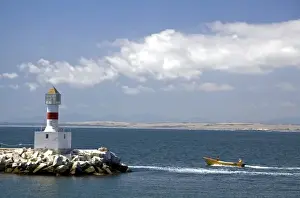 Republic Of Chile Prints: Lighthouse and motor boat off the coast of Concon in the Valparaiso Region of Chile