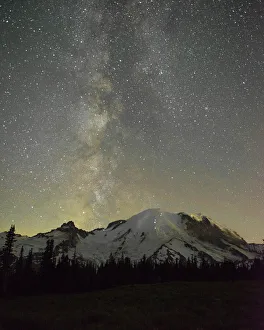 Images Dated 16th March 2020: The lights of climbers can be seen on the mountain as the Milky Way rises behind Mt