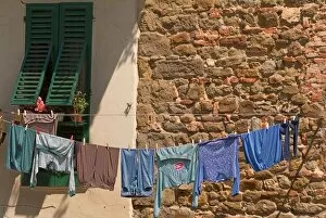 A line of clothes dries between buildings near an open air market in Figline, Tusacny, Italy