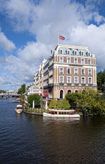 Local working boats on the canals in Amsterdam, the Netherlands