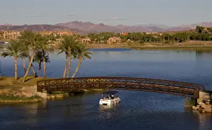 Marilyn Parver Prints: Loews Lake Las Vegas Resort, Reflection Bay bridge with a small boat going under