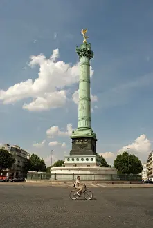 Bicycle Prints: A lone cyclist pedals in front of the Colonne de Julliet at Place de la Bastille