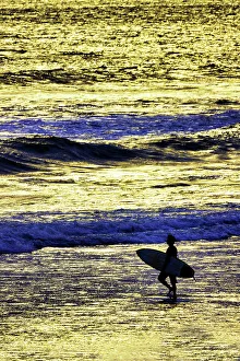 One Person Prints: Lone surfer along the beach entering the surf