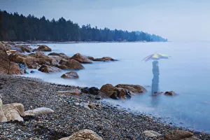 Mystery Prints: Long exposure of a ghostly image of woman in the sea with umbrella Sechelt