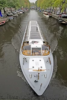 Images Dated 5th September 2007: A long glass topped tour boattravels down a boat lined canal