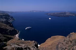 Looking down from Santorini at cliffs and cruise ship in Mediterranean