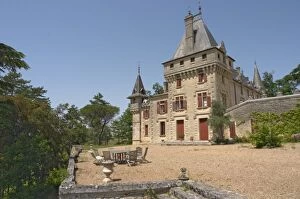 The magnificent Chateau de Pressac and garden furniture on the terrace Chateau de