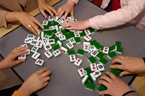 Mahjong players. A game of Chinese origin played by four persons with 144 dominolike