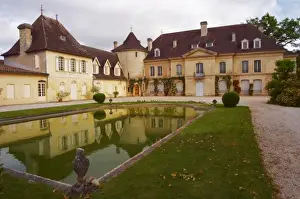 Cru Classe Prints: The main chateau building with its tower and a pond showing a reflection Chateau