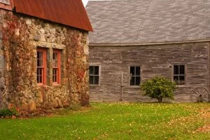 Maine, Old stone building and wooden barn in fall in rural New England