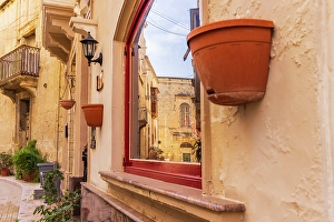 Malta Prints: Malta, Birgu. Window reflection of narrow streets and stone buildings