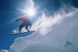 Sport Prints: Man jumping off a large cornince on a snowboard on Flagstaff Peak in the Wasatch
