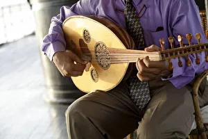 Still Life Prints: Man playing traditional Egyptian instrument. En Route to Luxor on the SS Sudan, Egypt