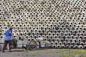 Cart Prints: Man pushing cart loaded with wine jars to the big pile in a winery, Zhejiang Province