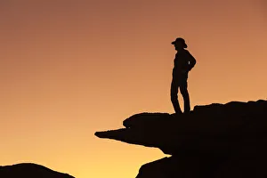 Man standing on rock surveying the view. (MR)