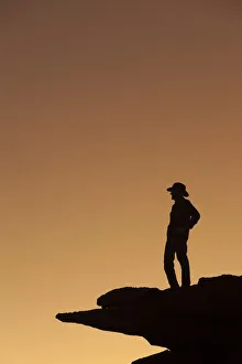 Prints of Man standing on rock surveying the view. (MR) Images Dated 2018 December: Man standing on rock surveying the view. (MR)