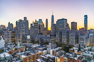 New York City Prints: Manhattan, New York, USA. Lights in the windows of skyscrapers at sunset