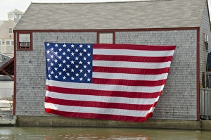 Images Dated 4th July 2012: Massachusetts, New England, Nantucket. Large flag on the side of boathouse