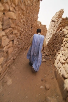 Images Dated 28th March 2006: Mauritania, Adrar, Ouadane, Man walking