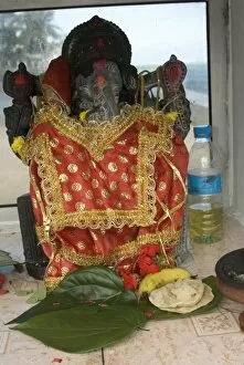 Mauritius, Baie du Cap. Roadside Hindu place of worship at the oceans edge containing Lord Ganesh