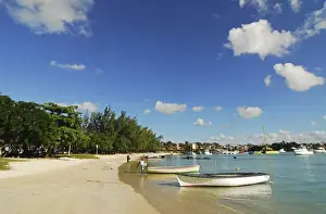 Grand Baie Prints: Mauritius, Grand Baie, boat at waters edge in a distance by calm sea