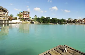 Peace Prints: Mauritius, Grand Baie, a small teddy bear on pier by river with turquoise water surrounded