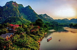 Cabin Prints: Mekong River village, Laos. Landscape view of mountain village at sunset lighting river and mountains