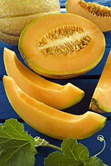 Whole melon and one cut into pieces (Cucumis melo)