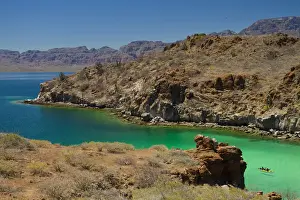 Sea Kayak Prints: Mexico, Baja, Sea of Cortez. Men in a double sea kayak paddle into azure-colored