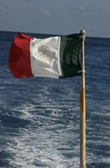 Mayan Riviera Prints: Mexico, Cozumel, dive boat with Mexican flag flying off the stern