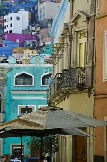 Stacked Prints: Mexico, Guanajuato. Densely packed assortment of multicolored buildings up a hillside