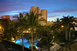 Condominium Prints: Mexico, Puerto Vallarta. A pool and resort at night