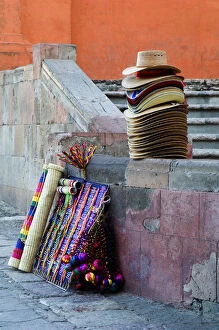 Mexico, San Miguel de Allende, Hats and other items for sale on street. Credit as