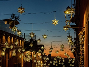 Star Prints: Mexico, San Miguel de Allende. Lighted stars suspended over a street at sunset