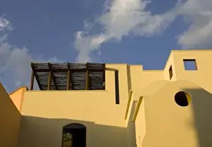 Images Dated 31st October 2006: Mexico, San Miguel de Allende. Roofline of yellow building against blue sky