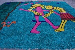 Mexico, San Miguel de Allende. Sidewalk art made from colored wood chips. Credit as