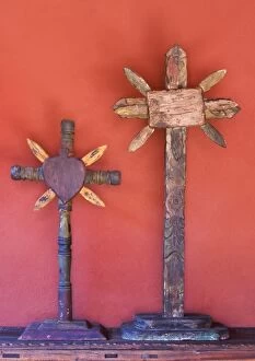 Mexico, San Miguel de Allende. Two wooden crosses against red wall
