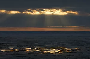 midnight sun over spring breakup of ice south of Barrow, National Petroleum Reserves