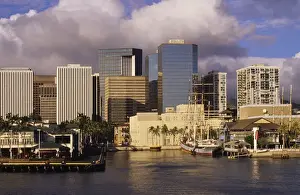 Jerry Ginsberg Prints: Modern skyscrapers contrast with vintage sailing ships of a bygone era in Honolulu harbor