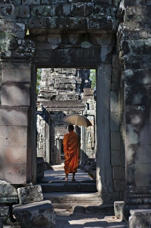 Monk with Buddhist statues in Banteay Kdei, UNESCO World Heritage site